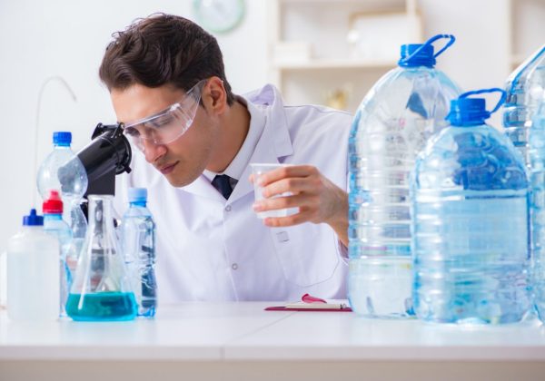 technician testing water samples in a lab